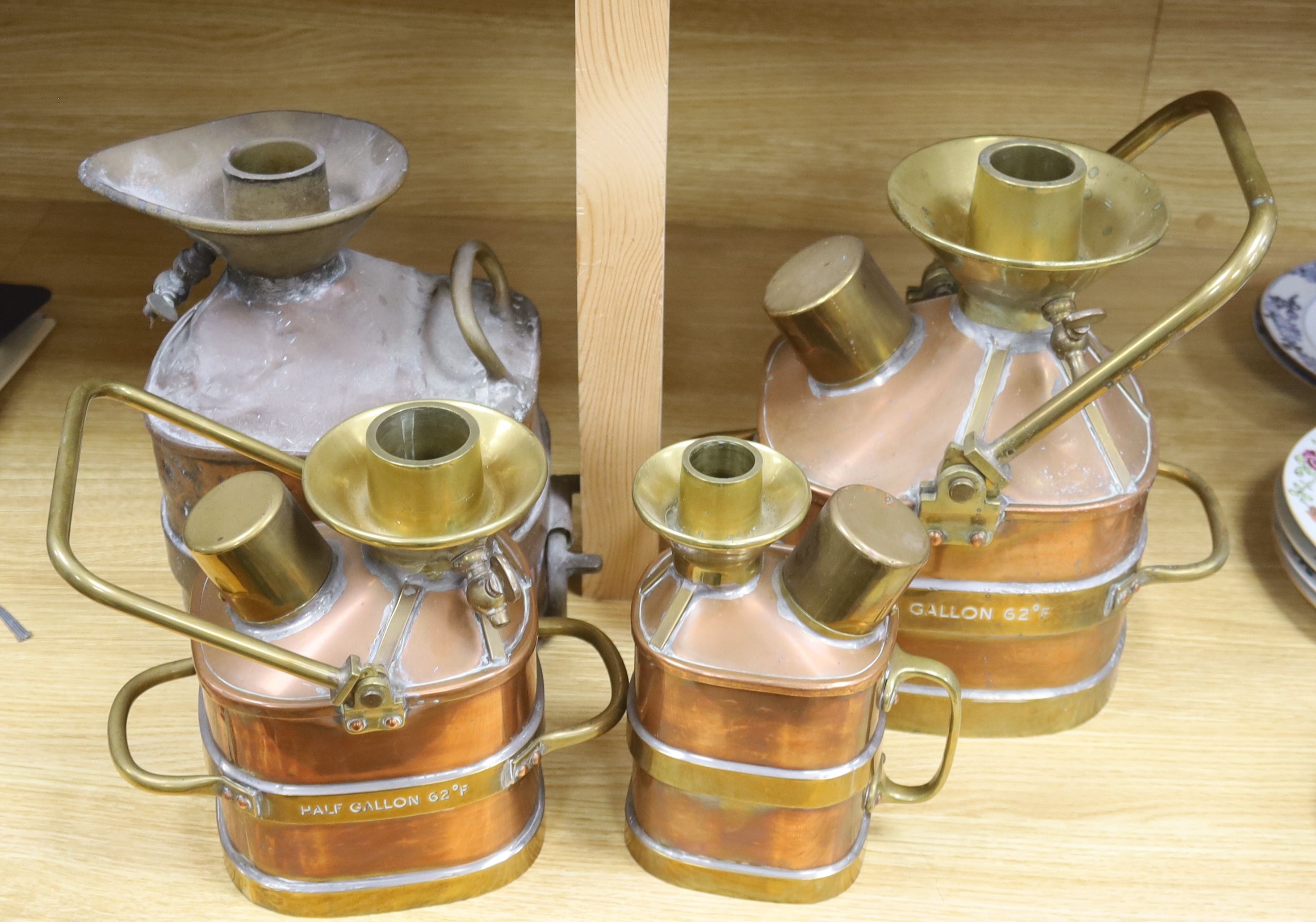 A group of four copper and brass mounted checkpumps, from quart size to one gallon, largest 28cm
